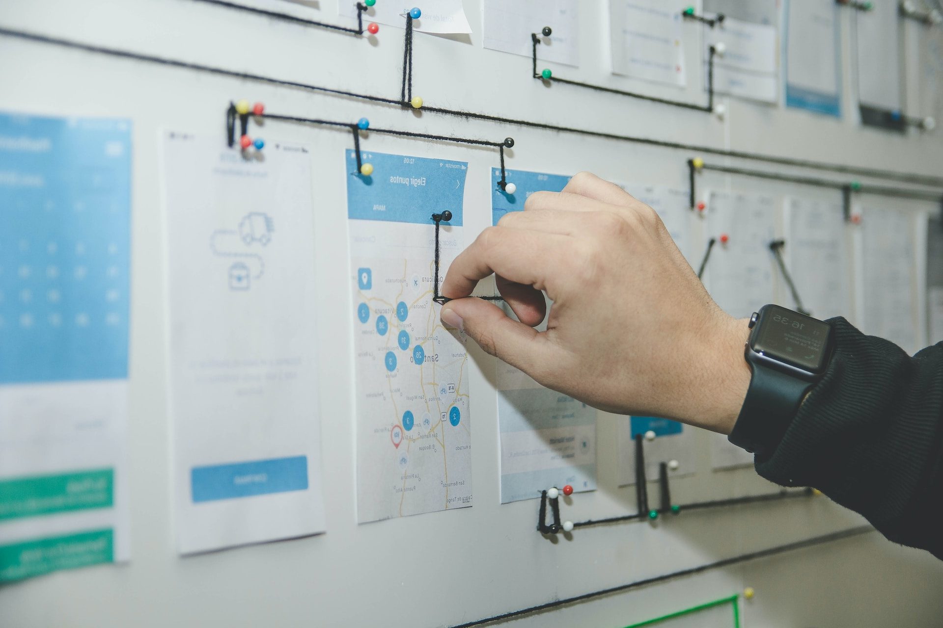 person working on blue and white paper on board